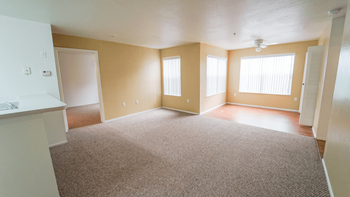 an empty living room with tan walls and tan carpet
